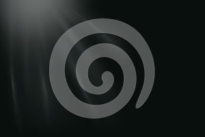 Soft white light rays on black background